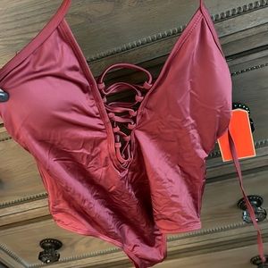 NWT Gianni Bini 1 piece. Size medium. Rose color. Sexy lace up front.